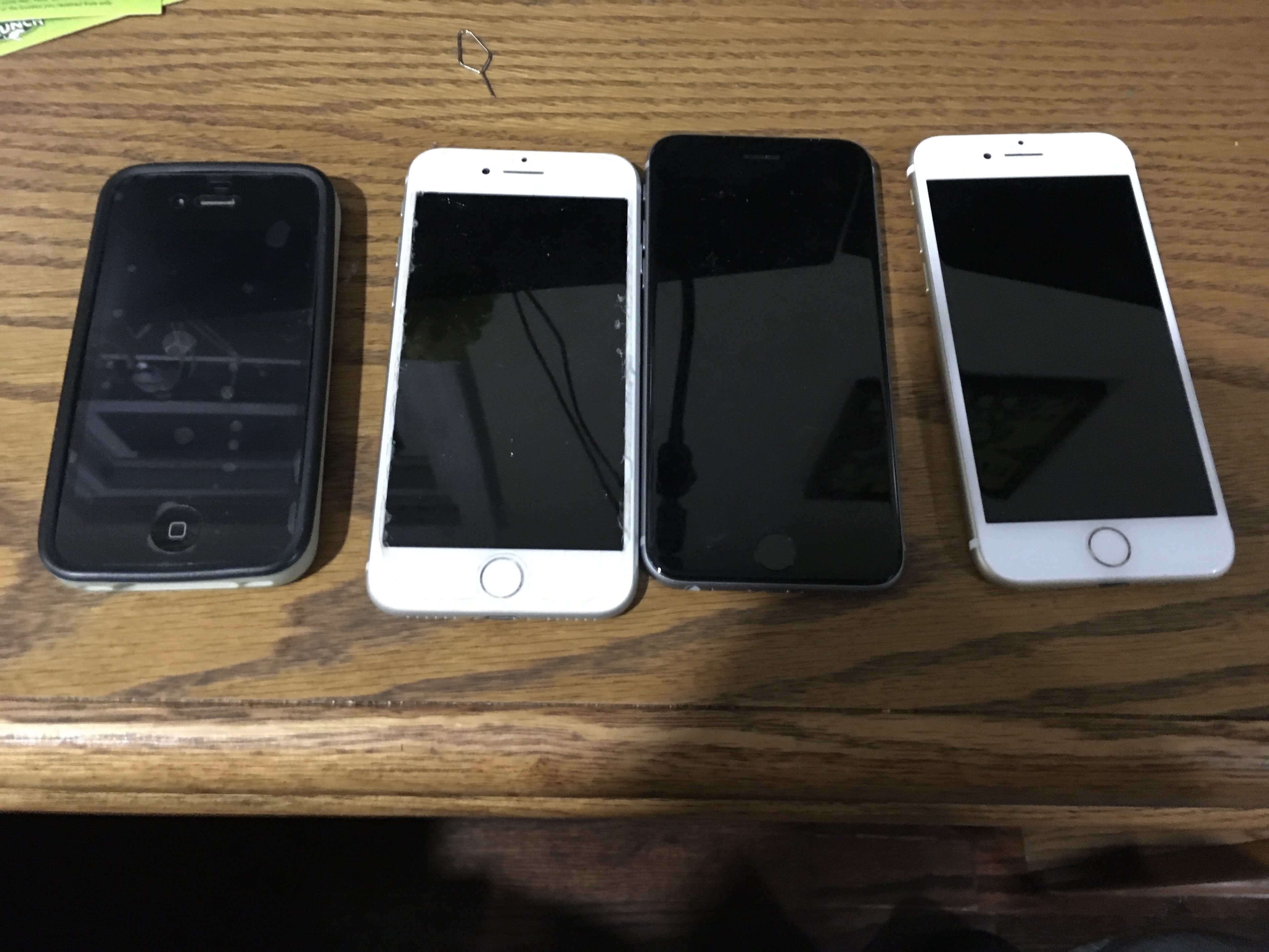Four iPhones on a desk